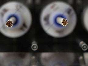 In this Thursday, Nov. 10, 2016 photo, test cigarettes sit in a smoking machine in a lab at the Centers for Disease Control and Prevention in Atlanta. On Friday, July 28, 2017, the U.S. Food and Drug Administration announced that it wants to lower nicotine levels in cigarettes so they aren&#039;t so addictive. (AP Photo/Branden Camp)