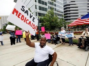 Mario Henderson leads chants of &ampquot;save Medicaid,&ampquot; as other social service activists, Medicaid recipients and their supporters stage a protest outside the building that houses the offices of U.S. Sen. Thad Cochran, R-Miss., Thursday, June 29, 2017, in Jackson, Miss. Soaring prices and fewer choices may greet customers when they return to the Affordable Care Act‚Äôs insurance marketplaces in the fall of 2017, in part because insurers are facing deep uncertainty about whether the Trump administratio