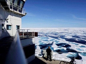 FILE - In this July 22, 2017 file photo, Canadian Coast Guard Capt. Victor Gronmyr looks out over the ice covering the Victoria Strait as the Finnish icebreaker MSV Nordica traverses the Northwest Passage through the Canadian Arctic Archipelago. After 24 days at sea and a journey spanning more than 10,000 kilometers (6,214 miles), the Finnish icebreaker MSV Nordica has set a new record for the earliest transit of the fabled Northwest Passage. The once-forbidding route through the Arctic, linking
