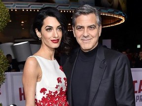 FILE - In this Feb. 1, 2016 file photo, Amal Clooney, left, and George Clooney arrive at the world premiere of &ampquot;Hail, Caesar!&ampquot; in Los Angeles. Clooney‚Äôs foundation is planning to open seven public schools for Syrian refugee children. The Clooney Foundation for Justice announced a new partnership Monday, July 31, 2017, with Google, HP and UNICEF to provide education for more than 3,000 refugee children in Lebanon. (Photo by Jordan Strauss/Invision/AP, File)