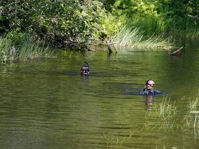 SQ dive teams search Pitobig Creek on the Kitigan Zibi First Nation on Tuesday after police received a tip regarding the disappearance of teenagers Maisy Odjick and Shannon Alexander. Sûreté du Québec photo