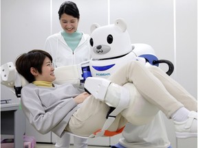 "Robear" lifts a woman for a demonstration in Nagoya, central Japan. Welcome to the new age of elder care, the age of robots.