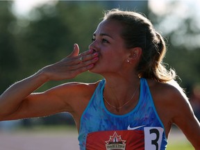 Melissa Bishop of Eganville blows a kiss to the crowd as she does a victory lap after winning gold in the women's 800-metre race at the Terry Fox Athletic Facility on Saturday evening. THE CANADIAN PRESS/Fred Chartrand