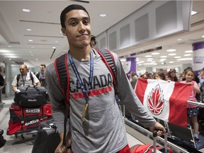 Kanata's Noah Kirkwood arrives at Toronto's Pearson International Airport with other members of Canada's under-19 basketball team after winning gold in the U19 FIBA World Cup in Cairo. THE CANADIAN PRESS/Chris Young