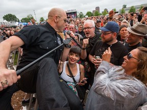 Hugh Dillon, frontman for the Headstones, climbs into the crowd during the group's RBC Bluesfest performance on Friday evening.