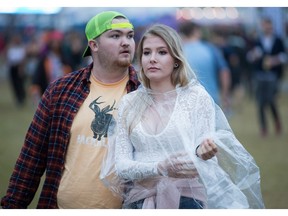 Sydney Bell, 16, came dressed for the rain while her friend Jeff Stanton, 18, took his chances on Friday night.