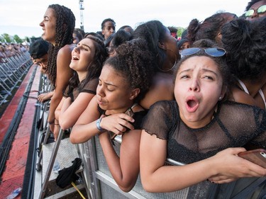 Young women react to the crushing crowd as they wait for Migos as day seven of the RBC Bluesfest takes place on the grounds of the Canadian War Museum.