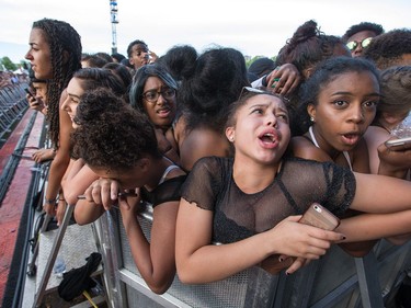 Young women react to the crushing crowd as they wait for Migos at RBC Bluesfest on Thursday, July 13, 2017.