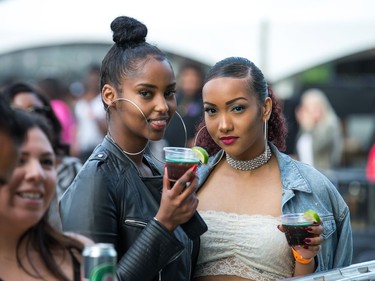 Two women escape the crushing crowd waiting for Migos by being in the VIP section as day seven of the RBC Bluesfest takes place on the grounds of the Canadian War Museum.