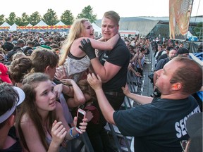 An overcome Lil Yachty fan is pulled from the crushing crowd as day seven of the RBC Bluesfest takes place on the grounds of the Canadian War Museum.