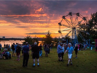 The sun sets across the Ottawa River as day five of the RBC Bluesfest takes place on the grounds of the Canadian War Museum.