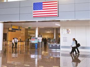 Airline Passengers head into the security screening before U.S. customs at the Calgary International Airport.