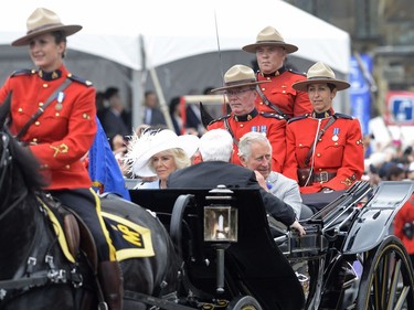 Camilla Duchess of Cornwall and Prince Charles ride in a carriage during Canada 150 celebrations in Ottawa on Saturday, July 1, 2017.