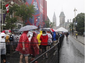 Members of the public wait in line to go through security screening before being allowed onto Parliament Hill on Canada Day in Ottawa on Saturday, July 1, 2017.
