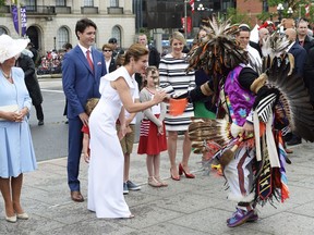 Sophie Gregoire Trudeau is given a feather by and indigenous dancer as Camilla Duchess of Cornwall and Prime Minister Justin Trudeau look on during Canada 150 celebrations in Ottawa on Saturday, July 1, 2017.