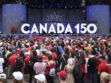 People look on during the Canada Day noon hour show on Parliament Hill in Ottawa on Saturday, July 1, 2017.