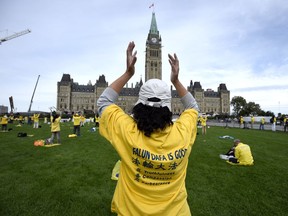 Members of Falun Gong rally on Parliament Hill in protest of what they say are state-led mass killings of Falun Gong practitioners for their organs, during an official visit of China's Premier Li Keqiang on Thursday, Sept. 22, 2016 in Ottawa. A media organization affiliated with the Falun Gong receives a great deal of funding, writes Stewart Kiff. THE CANADIAN PRESS/Justin Tang