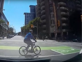 A video still of a cyclist hit by a car on Laurier Avenue and Lyon Street taken from a dashboard camera on Saturday by Nick Fleury.