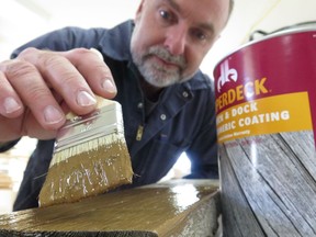 Steve Maxwell applying deck stain as part of his ongoing deck trials. Many deck finishes don't work, no matter how well you prepare the surface first.
