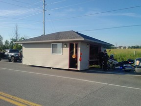 Police examine garage on a trailer stopped for numerous offences Thursday. 'Not sure we ever thought we'd ever see this!!'