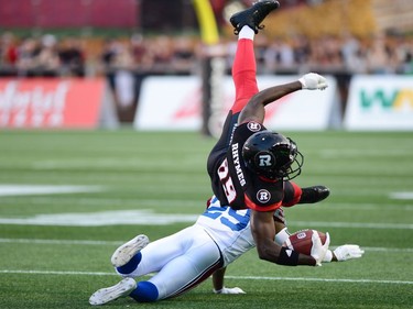 Ottawa Redblacks wide receiver Dominique Rhymes (89) is tackled by Montreal Alouettes defensive back Jonathon Mincy (29) during first half CFL football action in Ottawa on Wednesday, July 19, 2017.