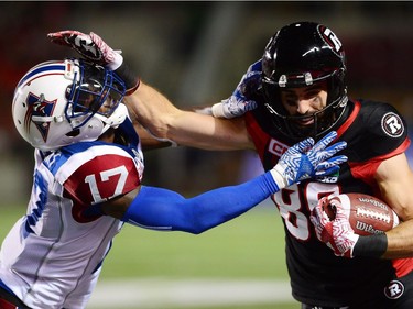 Ottawa Redblacks wide receiver Brad Sinopoli (88) fends off a tackle from Montreal Alouettes defensive back Brandon Stewart (17) during second half CFL football action in Ottawa on Wednesday, July 19, 2017.