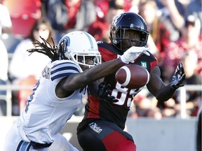 Argonauts defensive back Akwasi Owusu-Ansah, left, knocks down a pass intended for Redblacks wide receiver Dominique Rhymes during the first half of Saturday's game. THE CANADIAN PRESS/Patrick Doyle