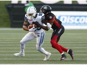 Argonauts wide receiver DeVier Posey (85) is tackled by the Redblacks defensive back Jonathan Rose (9) during the first half. THE CANADIAN PRESS/Patrick Doyle