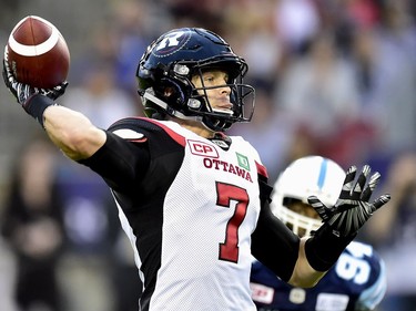 Ottawa Redblacks quarterback Trevor Harris (7) throws the pass during first half CFL action against the Toronto Argonauts, in Toronto, Monday, July 24, 2017.