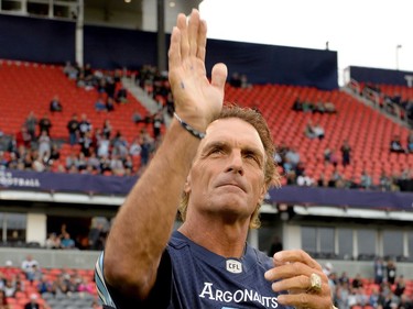 Former Argonauts player Doug Flutie salutes the crowd during a ceremony before first half CFL action in Toronto, Monday, July 24, 2017.
