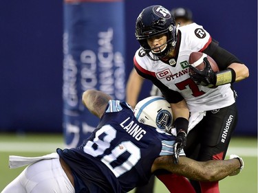 Ottawa Redblacks quarterback Trevor Harris (7) gets sacked by Toronto Argonauts defensive lineman Cleyon Laing (90) during first half CFL action in Toronto, Monday, July 24, 2017.