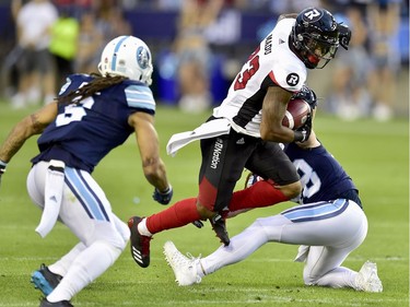 Ottawa Redblacks running back Mossis Madu Jr. (23) dodges a tackle attempt during first half CFL action against the Toronto Argonauts, in Toronto, Monday, July 24, 2017.