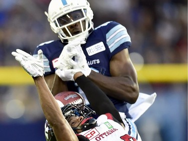 Toronto Argonauts wide receiver Jeff Fuller (8) and Ottawa Redblacks defensive back Corey Tindal (28) vie for control of the ball during first half CFL action in Toronto, Monday, July 24, 2017.