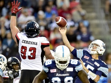 Toronto Argonauts quarterback Ricky Ray (15) lets a pass fly as Ottawa Redblacks defensive lineman Jake Ceresna (93) attempts to block during first half CFL action in Toronto, Monday, July 24, 2017.