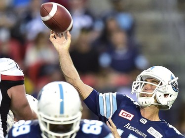 Toronto Argonauts quarterback Ricky Ray (15) lets a pass fly as Ottawa Redblacks defensive lineman Jake Ceresna (93) attempts to block during first half CFL action in Toronto, Monday, July 24, 2017.