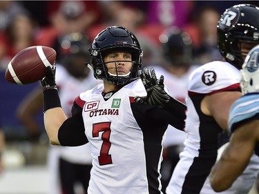 Ottawa Redblacks quarterback Trevor Harris (7) looks for the pass during first half CFL action against the Toronto Argonauts, in Toronto, Monday, July 24, 2017.