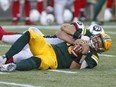 Redblacks' Arnaud Gascon-Nadon wraps up the Eskimos' Mike Reilly for one of his two quarterback sacks during last Friday's game at Edmonton. THE CANADIAN PRESS/Jason Franson