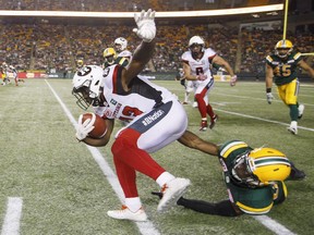 The Redblacks' Daje Johnson (13) is tackled by the Eskimos' Kenny Ladler (37) during second-half action last Friday in Edmonton. THE CANADIAN PRESS/Jason Franson