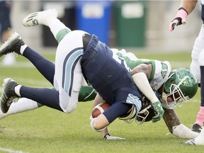 Jonathan Newsome sacks quarterback Drew Willy during the Roughriders/Argonauts game in Toronto on Oct. 15, 2016. THE CANADIAN PRESS/Frank Gunn