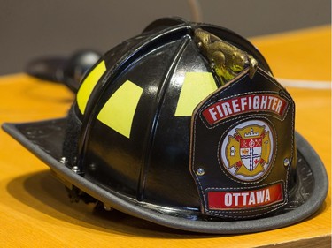 A Firefighter helmet on a councillors desk as Ottawa Fire Services hosts a graduation ceremony to welcome its newest probationary firefighters at Ottawa City Hall.