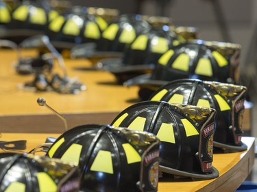 Firefighter helmets line the councillors desks as Ottawa Fire Services hosts a graduation ceremony to welcome its newest probationary firefighters at Ottawa City Hall.