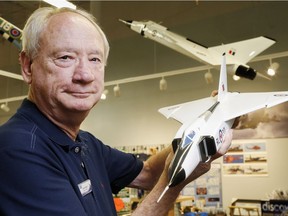 This file photo shows executive director Chris Colton of the National Air Force Museum of Canada holding a model of the Avro Arrow in front of a larger hanging version at the museum in Trenton, Ont., On Friday it was announced that a test model of the aircraft was discovered on the floor of Lake Ontario.