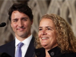 A pleased Prime Minister Justin Trudeau looks on as former astronaut and Governor General-designate Julie Payette, talks to reporters on Parliament Hill on July 13, 2017. (THE CANADIAN PRESS/Fred Chartrand)