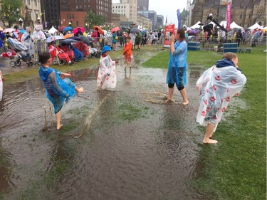 From left: Jasmine Flood, Ainsley Johnstone, Rowen Flood, Braeden Johnstone make the best of a swampy Parliament Hill on Canada Day.