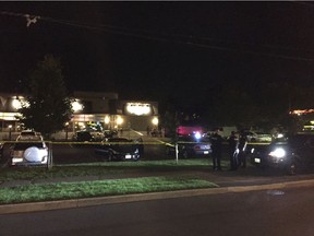 The parking lot to the businesses in the 2700 block of Iris Street is cordoned off behind police vehicles and tape on the evening of July 31, 2017.