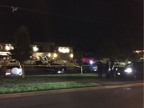 The parking lot to the businesses in the 2700 block of Iris Street is cordoned off behind police vehicles and tape on the evening of July 31, 2017.