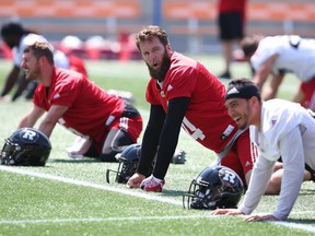 Third-string QB Ryan Lindley, middle, and his teammates get in some stretching during practice at TD Place stadium on Monday.  Jean Levac/Postmedia