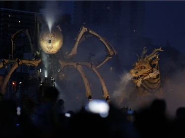 Thousands of people gathered to see La Machine's mechanical dragon-horse Long Ma walk from Chaudière Falls to meet its giant spider counterpart Kumo at the National War Museum for their grand finale in Ottawa on Sunday. David Kawai/Postmedia