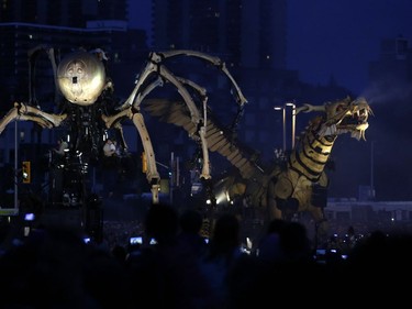 Thousands of people gathered to see La Machine's mechanical dragon-horse Long Ma walk from Chaudière Falls to meet its giant spider counterpart Kumo at the National War Museum for their grand finale in Ottawa on Sunday. David Kawai/Postmedia