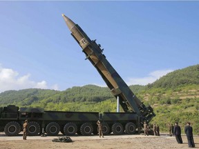 In this photo distributed by the North Korean government, North Korean leader Kim Jong Un, second from right, inspects the preparation of the launch of a Hwasong-14 intercontinental ballistic missile, ICBM, in North Korea's northwest Tuesday, July 4, 2017. Independent journalists were not given access to cover the event depicted in this photo.